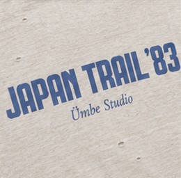 The chest print close up: JAPAN TRAIL ’83 in blue condensed capitals over Ümbe Studio in italic, printed on pale heather slub jersey that has been distressed.