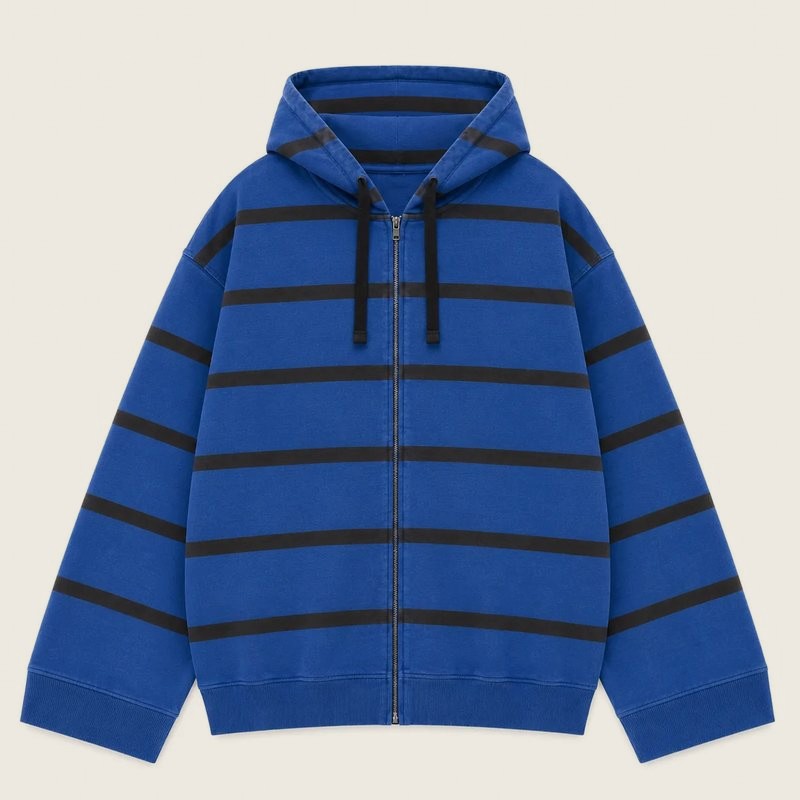 An oversized zip hoodie in cobalt blue with wide black horizontal stripes, shown flat.