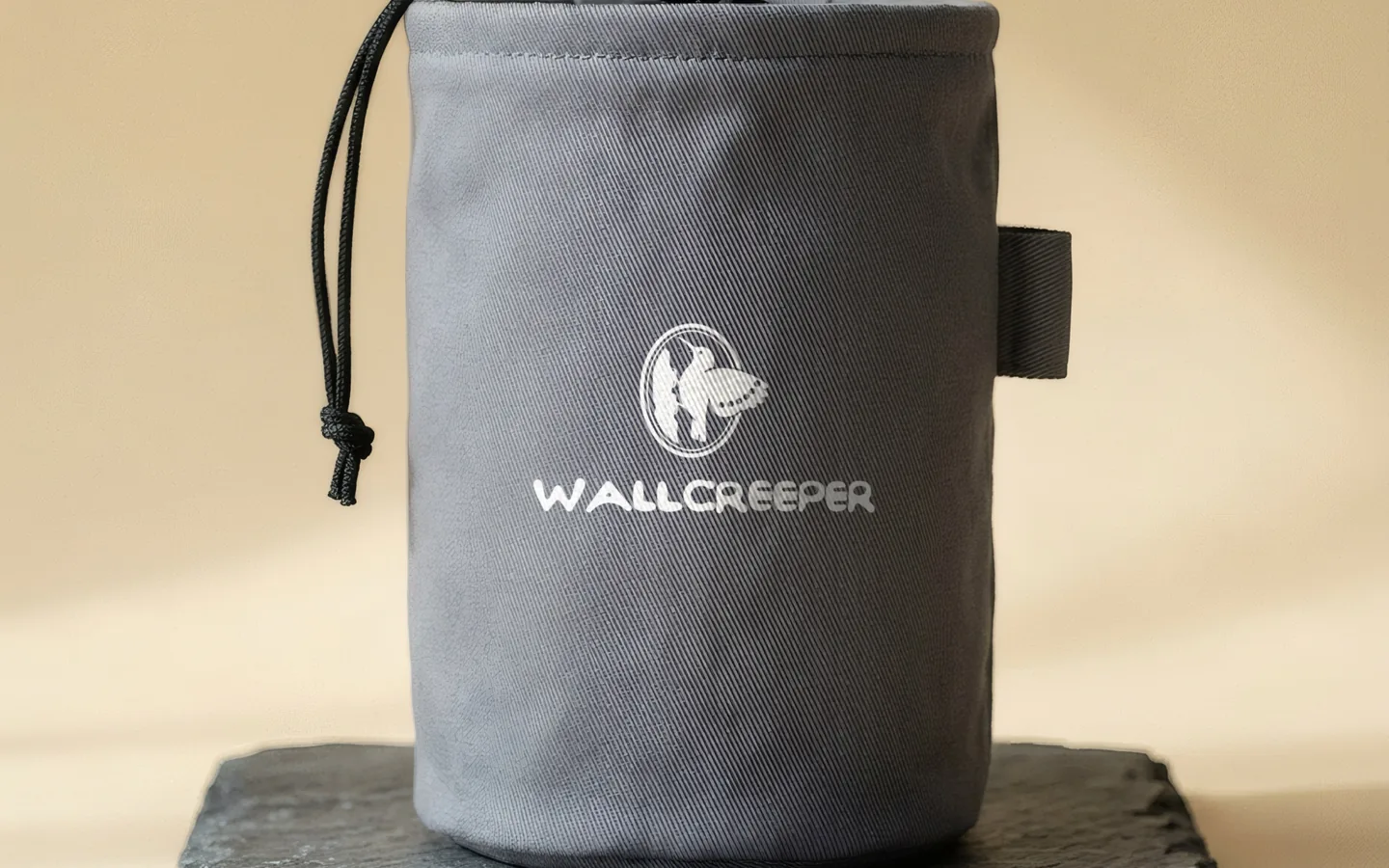 Wallcreeper: a climbing chalk bag carrying the label’s bird mark.